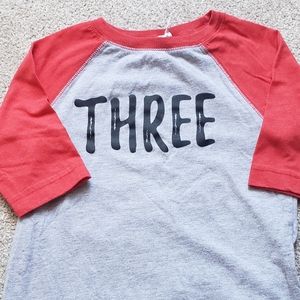 "Three" raglan style shirt. Size 3T
